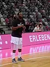 Jimmy McKinney is shooting a 3-pointer for a team in Germany