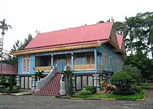 Rumah Lipat Kajang style, a Sumatran Riau Malay traditional house with tiled stairs at Taman Mini Indonesia theme park.