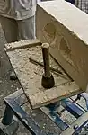 A modern stonemason's workbench with a block of limestone