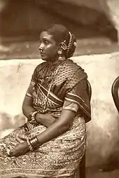 Woman in Tamil sari; in this style, the loose end is wrapped around the waist