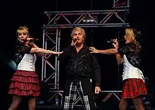 Two women and a man performing on stage