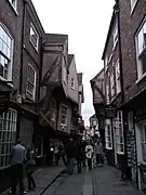 Jettied buildings overhang the street by several feet