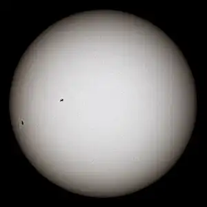 White glowing ball with black sunspots