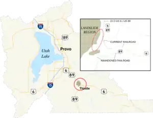 Map showing an area of Utah County circled and enlarged to the southeast of Utah Lake. The enlarged area shows an abandoned rail and highway grades to the west and south of replacement rail and highway grades.