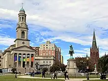 Photograph of a statue and churches in Thomas Circle