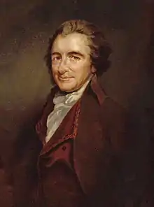 Half=length portrait of a man turned towards the left and looking inquiringly out towards the viewer. He is wearing a dark red velvet jacket and a white shirt and there are papers next to him.