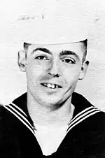 A black-and-white photo portrait of a man in a naval sailor's military uniform