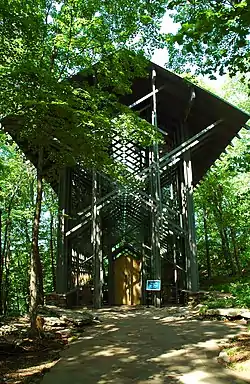 Front of the Thorncrown Chapel partially obscured by trees