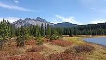 Three Fingered Jack can be seen in the top left of the image, with a heavily forested area and a lake beneath