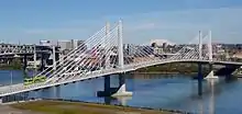 Top: A westbound Type 2 Blue Line train crossing the Steel Bridge
Bottom: A MAX train and a Portland Streetcar tram traversing Tilikum Crossing