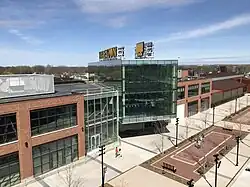 View of a three-story brick and glass building with a large gold sign saying Titletown on the roof