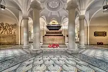 Picture of the sarcophagus of Nelson, with the tribute to Cooke on the left, in the crypt of St Paul's Cathedral