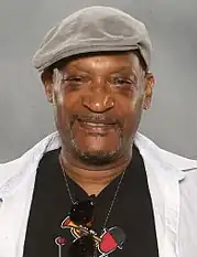 Tony Todd, an African-Americal male, is looking directly at the camera wearing a hat.