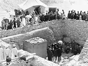 Crowds standing around and inside a walled pit