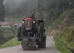 A tractor-driven road roller