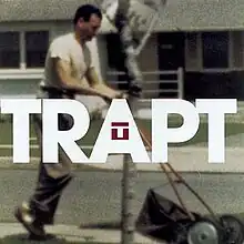 The cover features a man wearing a white t-shirt and beige pants using a lawnmower. The band's name appears over the photo, colored in white, and the band logo is featured on the 'A'.