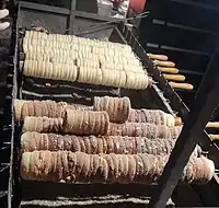 Trdelník being baked in a stall in Wenceslas Square, Prague