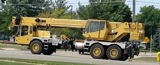 A truck-mounted crane in road travel configuration