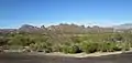 The foothills south of the Tucson Mountains. Beehive Peak is at the center-left, Cat Mountain is at the far left. The Catalina Mountains are in the background at right.