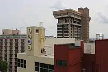 Upper part of beige and brick red manufacturing plant buildings