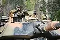 M1A1 in the Australian Army's Disruptive Pattern Camouflage, used for vehicles and materiel. Smoke grenade launchers are seen at left.