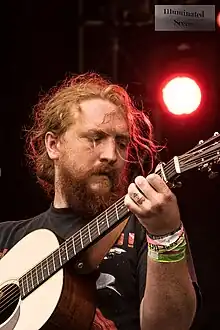 Singer Tyler Childers, holding an acoustic guitar