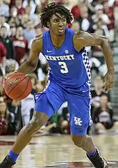 Maxey, in a blue basketball jersey with the number 3, handles a basketball.