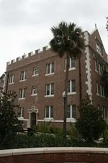 Exterior of Buckman Hall, a red brick and carved stone student residence hall at the University of Florida, built in 1905–06 in the then-popular collegiate gothic architectural style