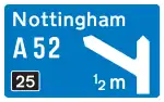 Motorway junction ahead, displaying the route number and destination reached by taking this route