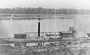 Black and white photo of a monitor with low freeboard. On the left is its single turret.