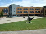 The School of Management Building with the statue of Alan Turing in the middle distance.