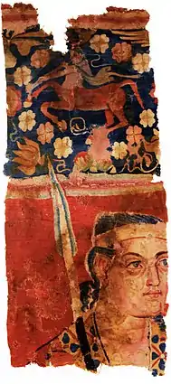 The Sampul tapestry, a woollen wall hanging from Lop County, Hotan Prefecture, Xinjiang, China, showing a possibly Greek soldier from the Greco-Bactrian kingdom (250–125 BC), with blue eyes, wielding a spear, and wearing what appears to be a diadem headband; depicted above him is a centaur, from Greek mythology, a common motif in Hellenistic art; Xinjiang Region Museum.