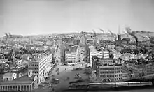 A black-and-white pencil drawing of a bustling, smoky, industrial city.