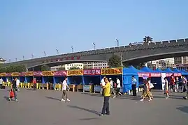 Welcome booths set up by Xi'an's university and colleges for their new students on the plaza in front of Xi'an railway station