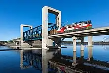 An Sr1 locomotive pulling lumber across a lift bridge north of Kuopio railway station in Finland