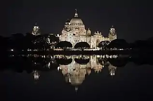 Victoria Memorial illuminated at night.