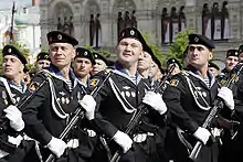 Russian marines parade in navy blue dress uniform, with a matching navy blue telnyashka.