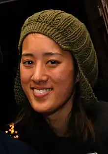 Vienna Teng wearing green wool knit hat, grinning at camera