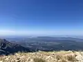 View looking north-west from Olenos Peak of Mount Erymanthos. Visible on the horizon are the islands of Zakynthos (left) and Kephalonia (right). Distance from Olenos peak to the Kephalonia's Ainos peak is about 64 miles.