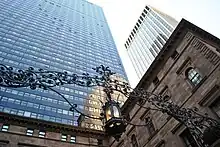 Looking up at the Palace Hotel's skyscraper from ground level, with the Villard Houses in the foreground