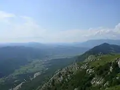 A photo showing a valley and a mountain