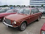 1975 164 front illustrating updated front bumper, grille and redesigned doors.