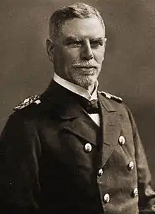 An older man in a double-breasted naval uniform