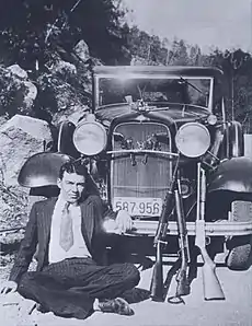 W. D. Jones and the gang's guns, April 1933. The cut-down shotgun is one of Barrow's "whippit" guns. The pistol decorating the hood ornament is Officer Persell's.