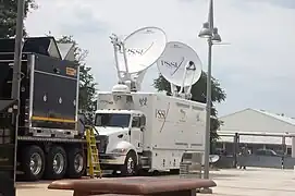 A WWE HD satellite truck in a parking lot.