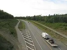 View of a highway surrounded by forest.