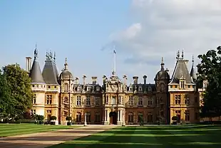 large two-storey brick building with a number of large pointed turrets on the roof