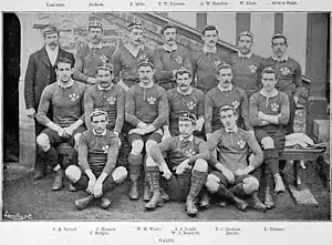 The full Welsh squad lining up for the purpose of a pre-match photo. Gould is seated centrally, dwarfed by his larger teammates.