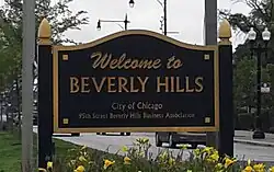 Black sign with gold lettering that says "Welcome to Beverly Hills / City of Chicago / 95th Street Beverly Hills Business Association".