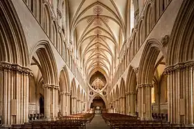 Nave of Wells Cathedral, with its strong horizontal emphasis. The unusual double arch was added in 1338 to reinforce the support of the tower.